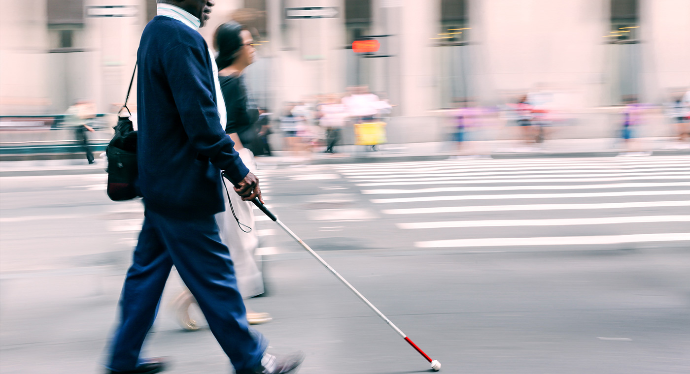 blind man walking with a stick
