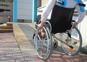 550x395 housing 1 person in wheelchair going up a ramp
