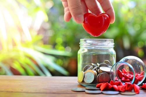 adding heart to a donation jar