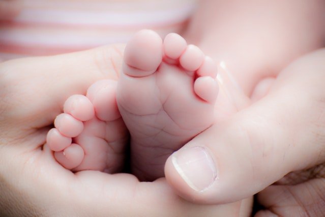hands holding baby feet